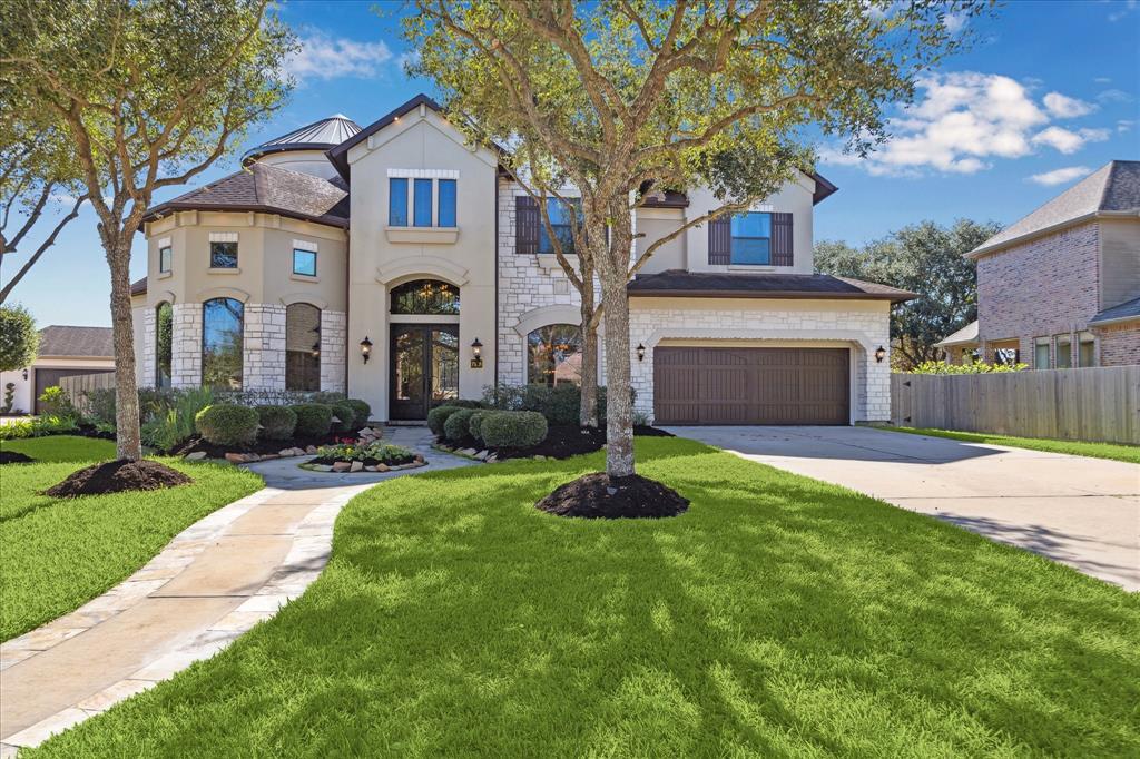 a front view of a house with a garden and yard