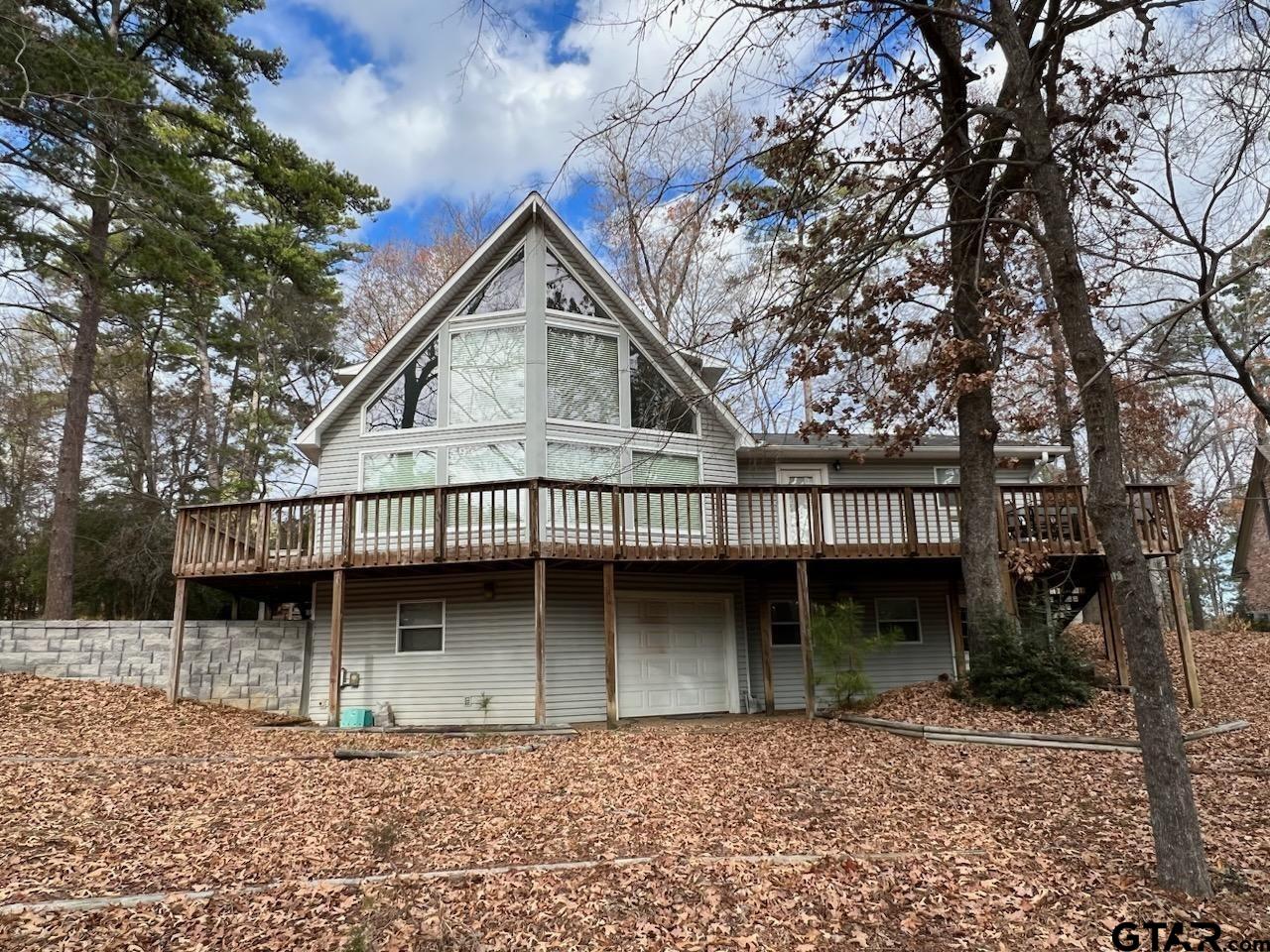 a house with lots of trees in the background