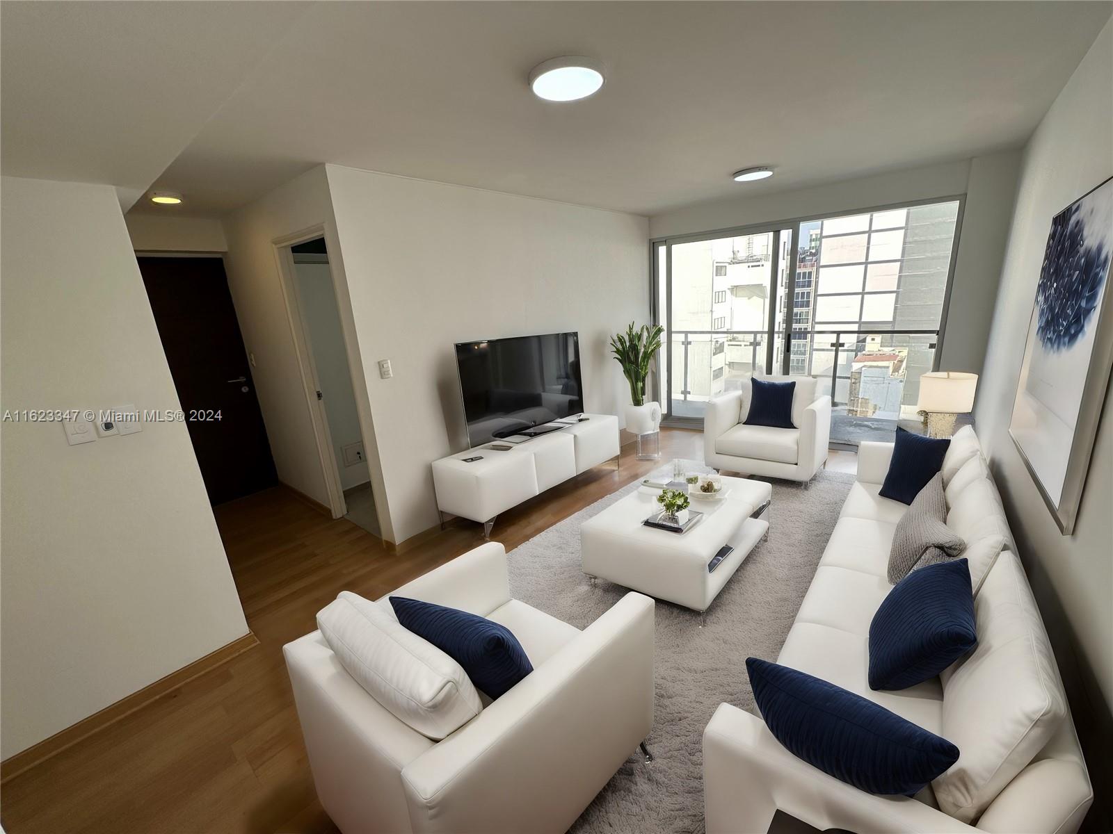 a living room with furniture and a flat screen tv