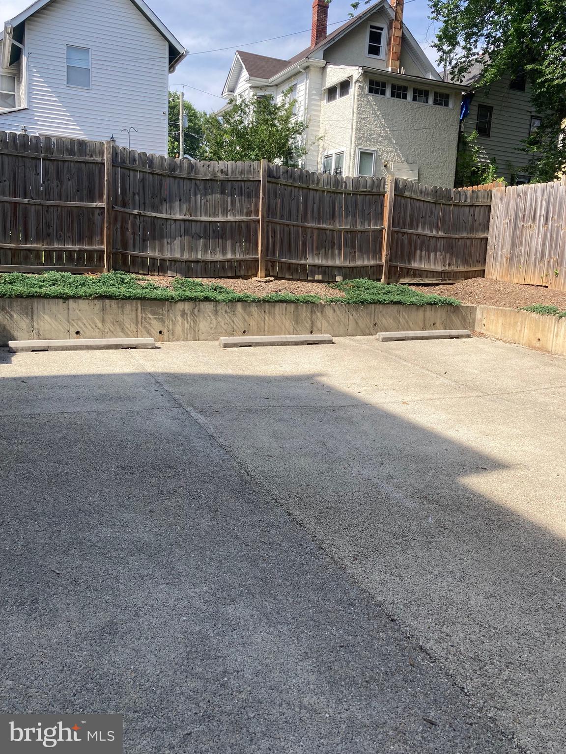 a view of backyard and wooden fence