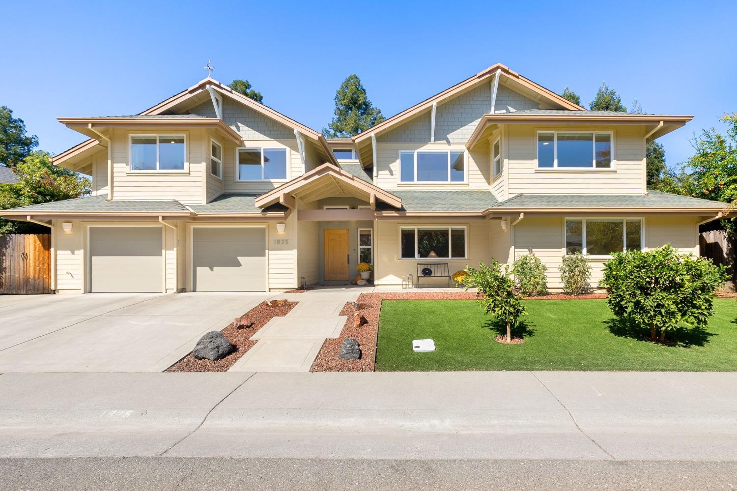 a front view of a house with a garden