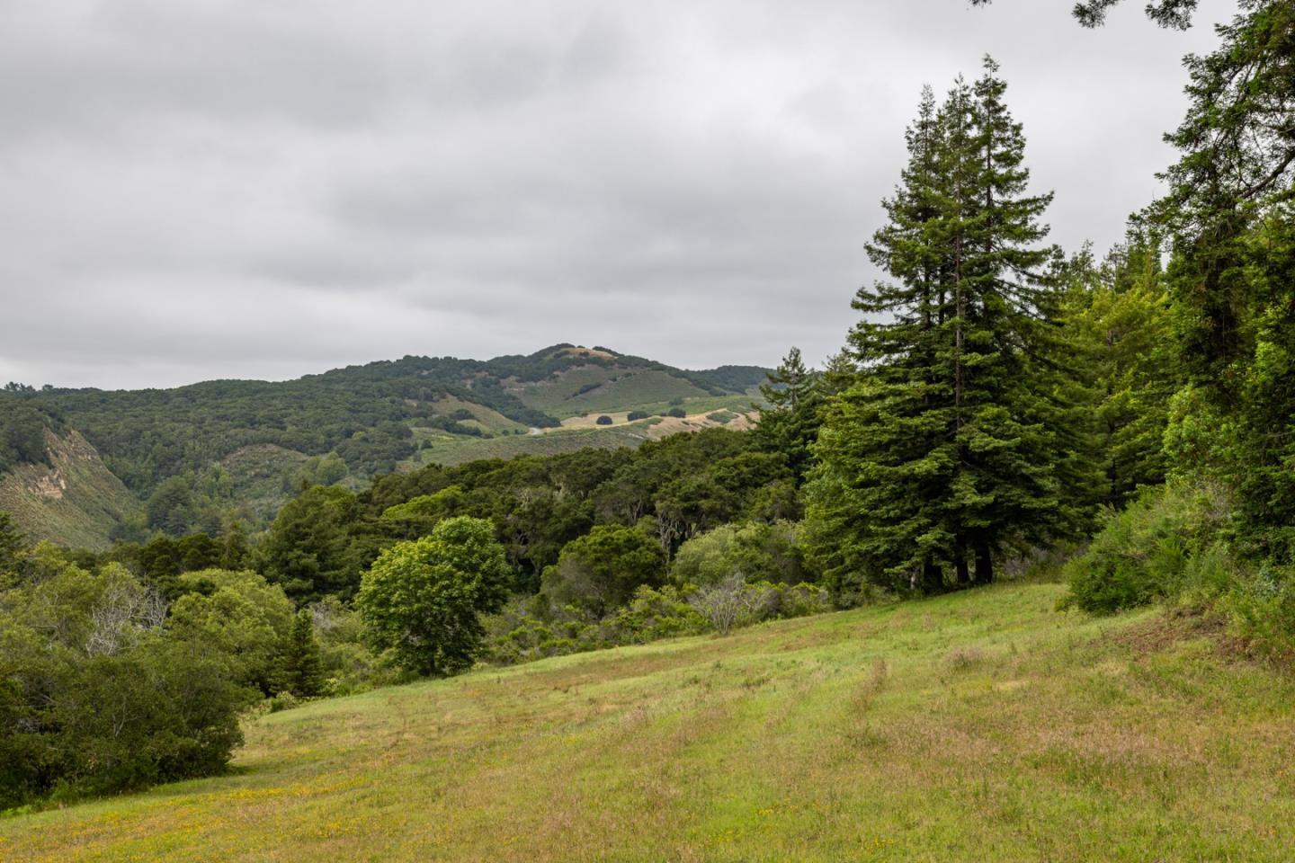 a view of a large mountain with mountains in the background