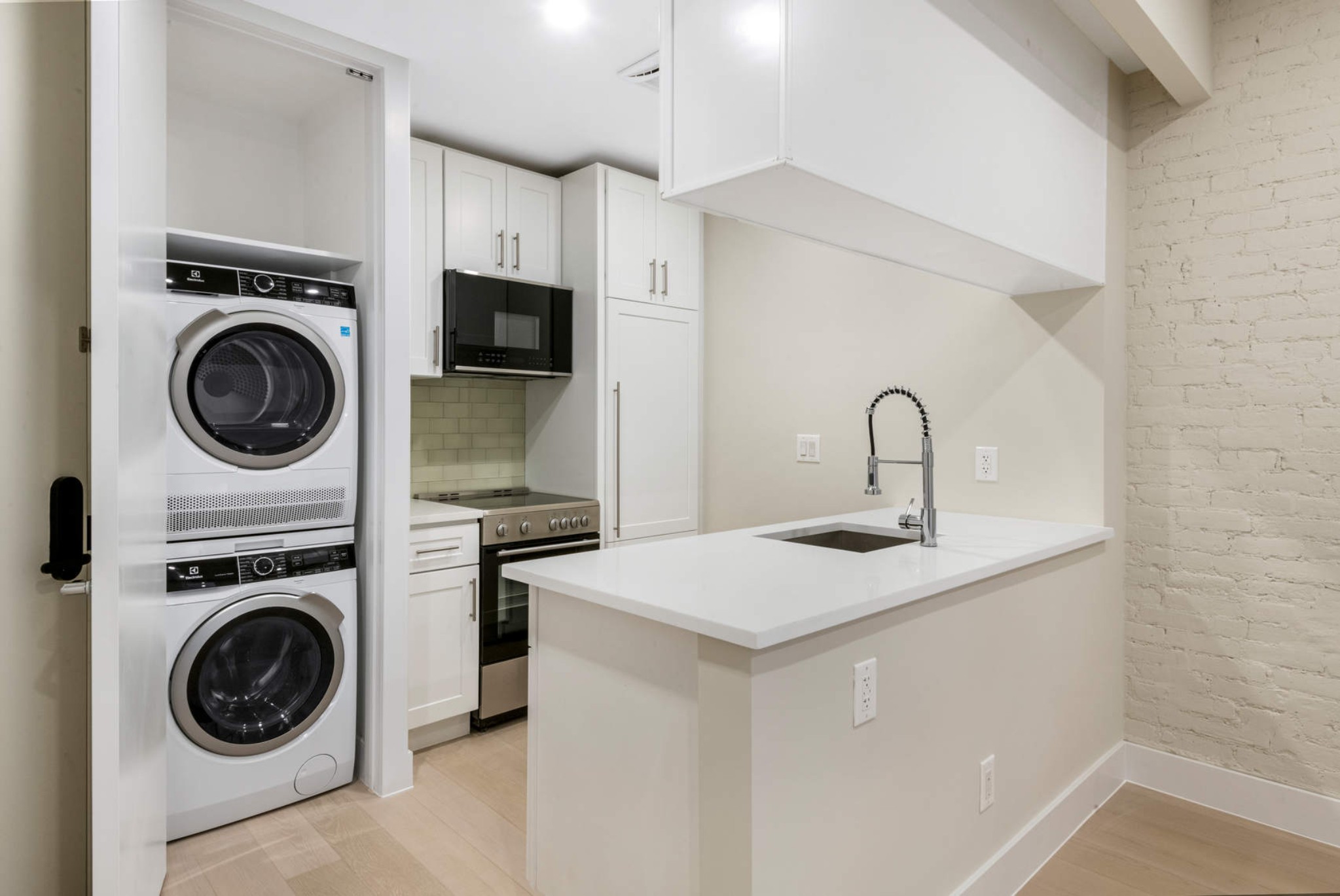 a kitchen with a sink a washer and dryer