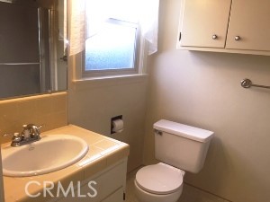 a white toilet sitting next to a bathroom sink