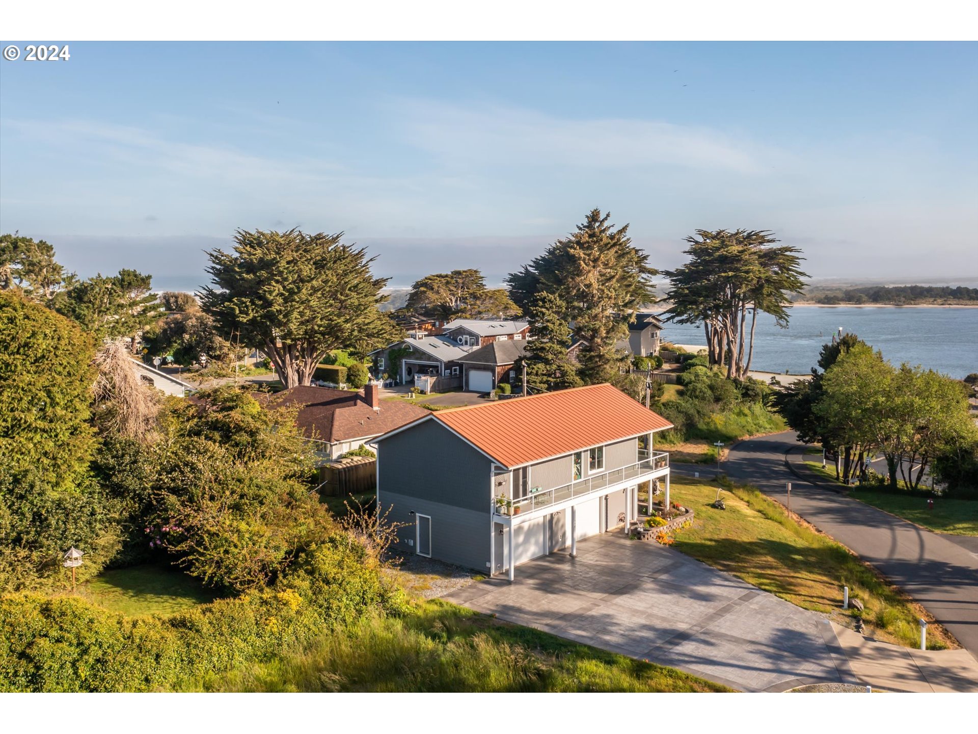 a view of a house with a yard and lake view