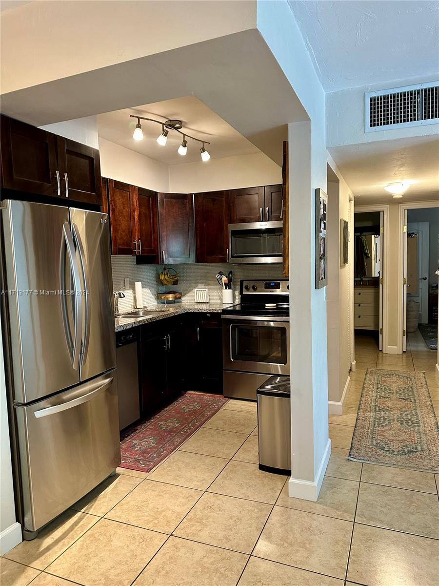 Stainless steel Appliances, Solid Wood Cabinets, and Granite Countertops.