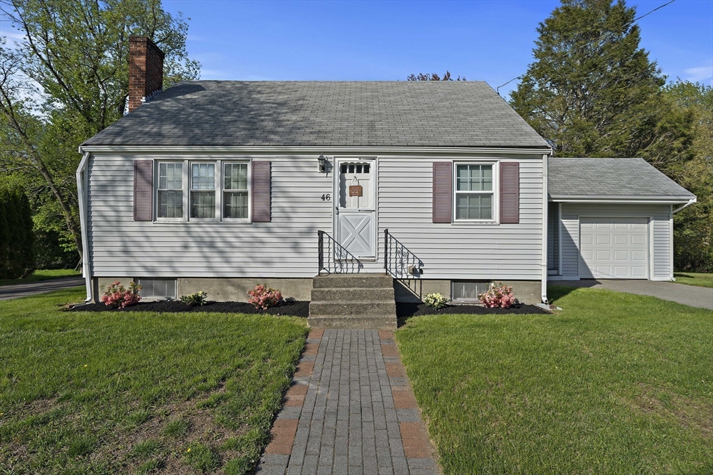 a front view of house with yard and green space