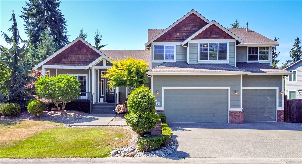 a front view of a house with a yard and garage