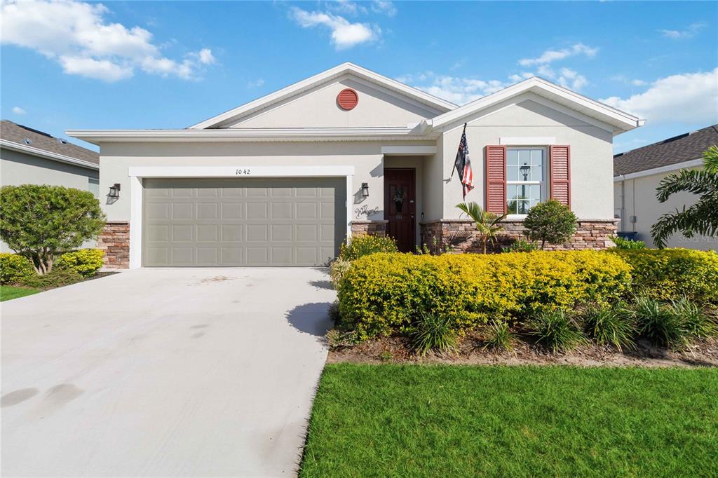 a front view of a house with a yard and garage