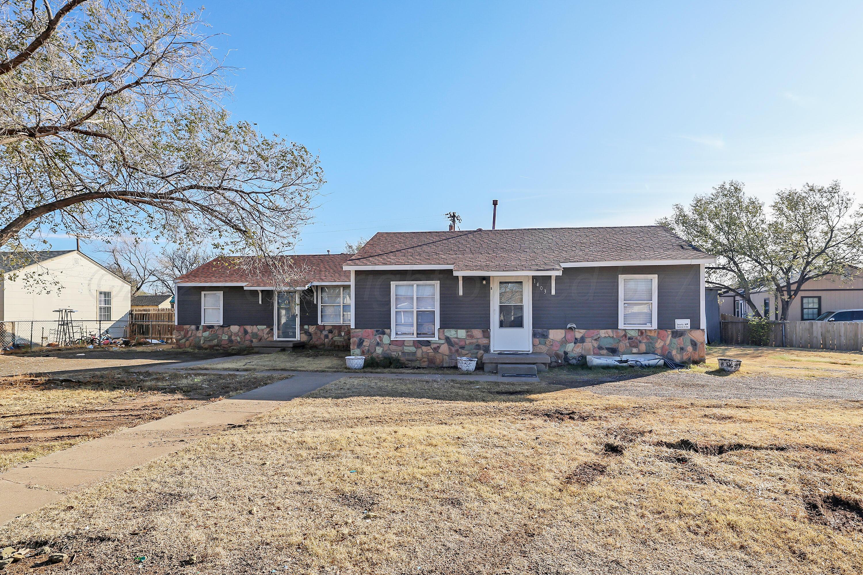 a front view of a house with a yard covered in snow