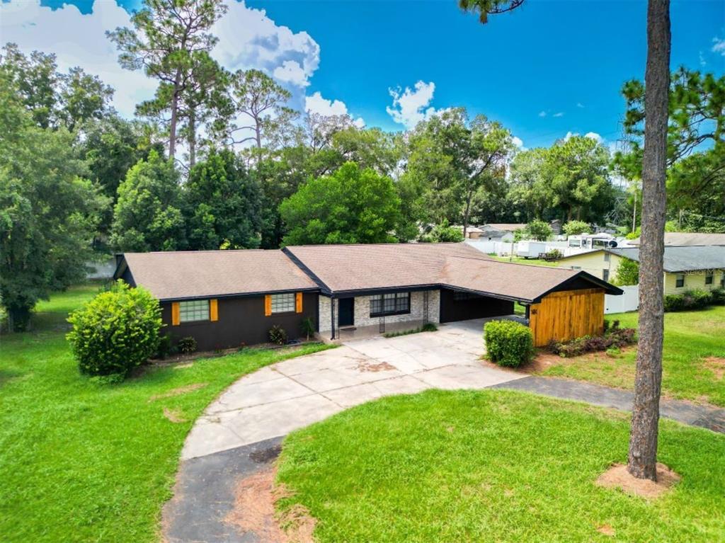 a aerial view of a house with yard patio and green space