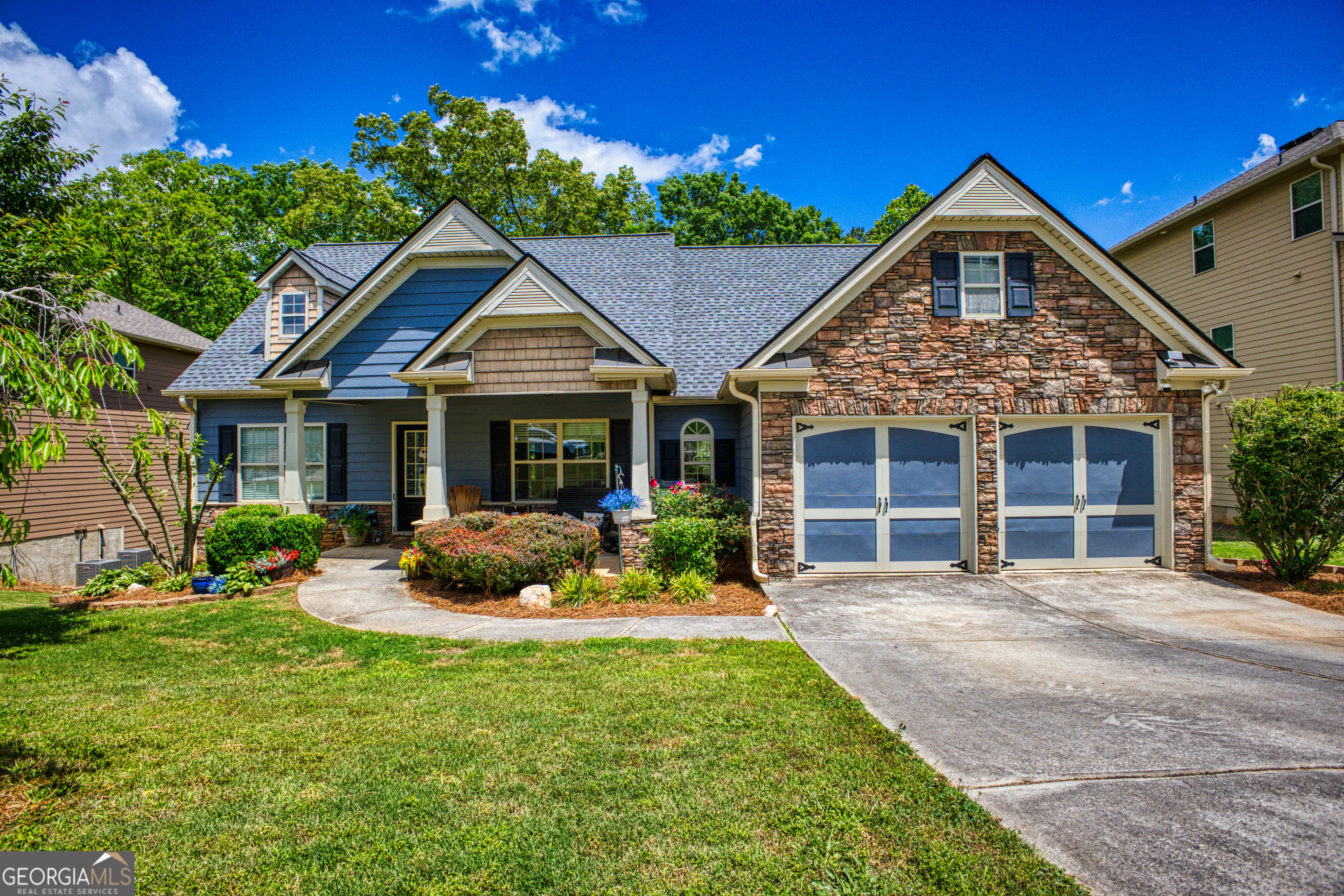 a front view of a house with yard and porch