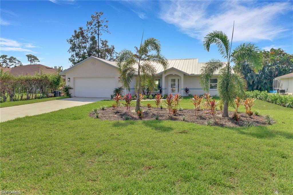 Ranch-style home with a front yard and a garage