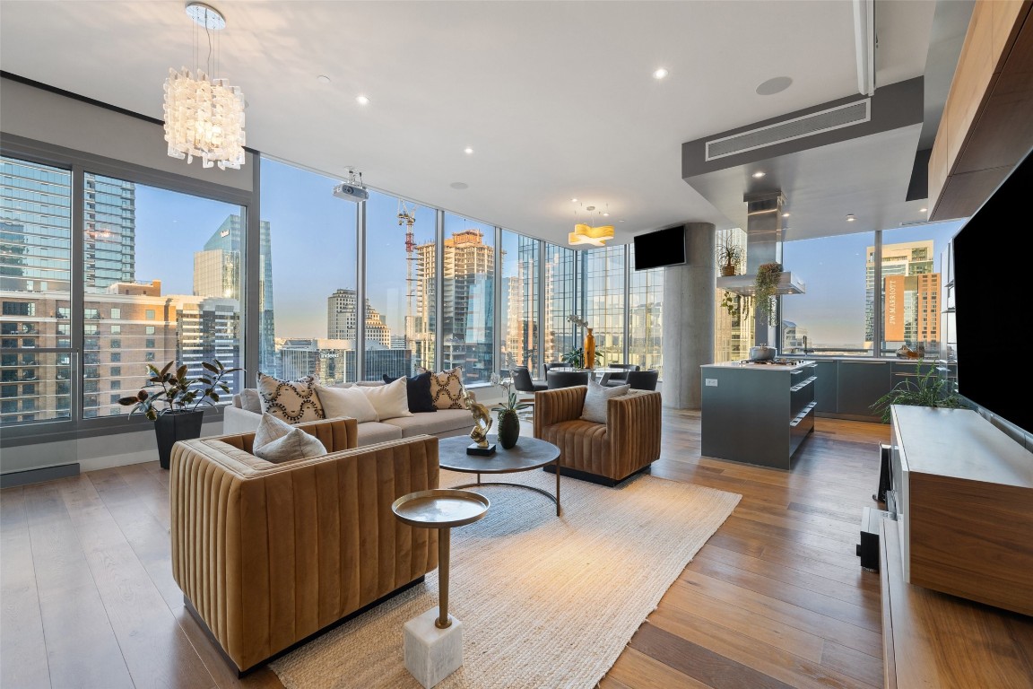 a living room with furniture wooden floor and a large window