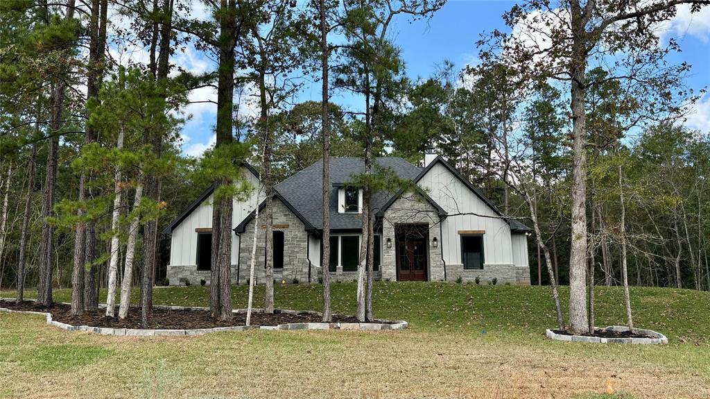 Modern European farmhouse elevation with brick, stone and Hardi accents