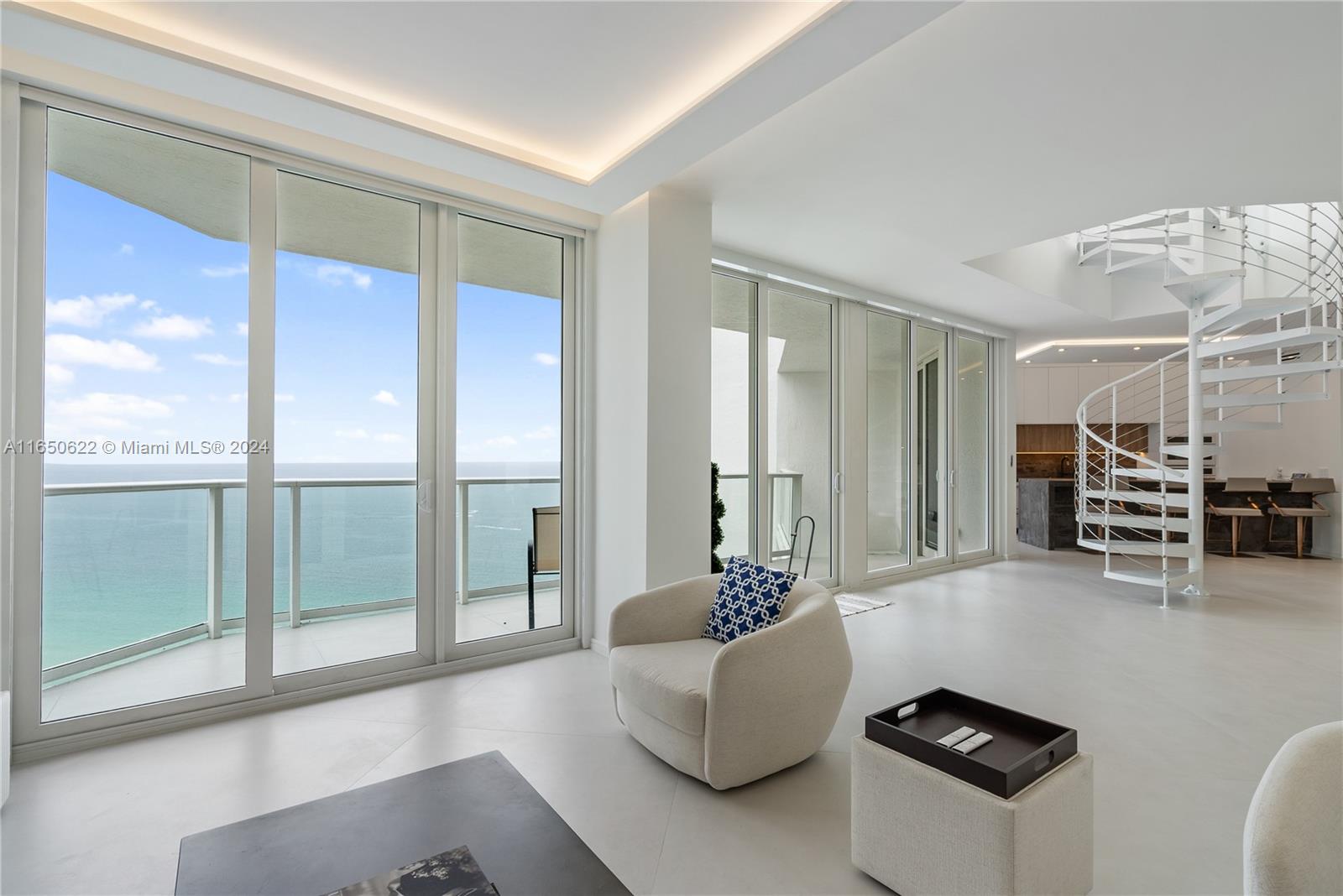 a living room with furniture and large glass door