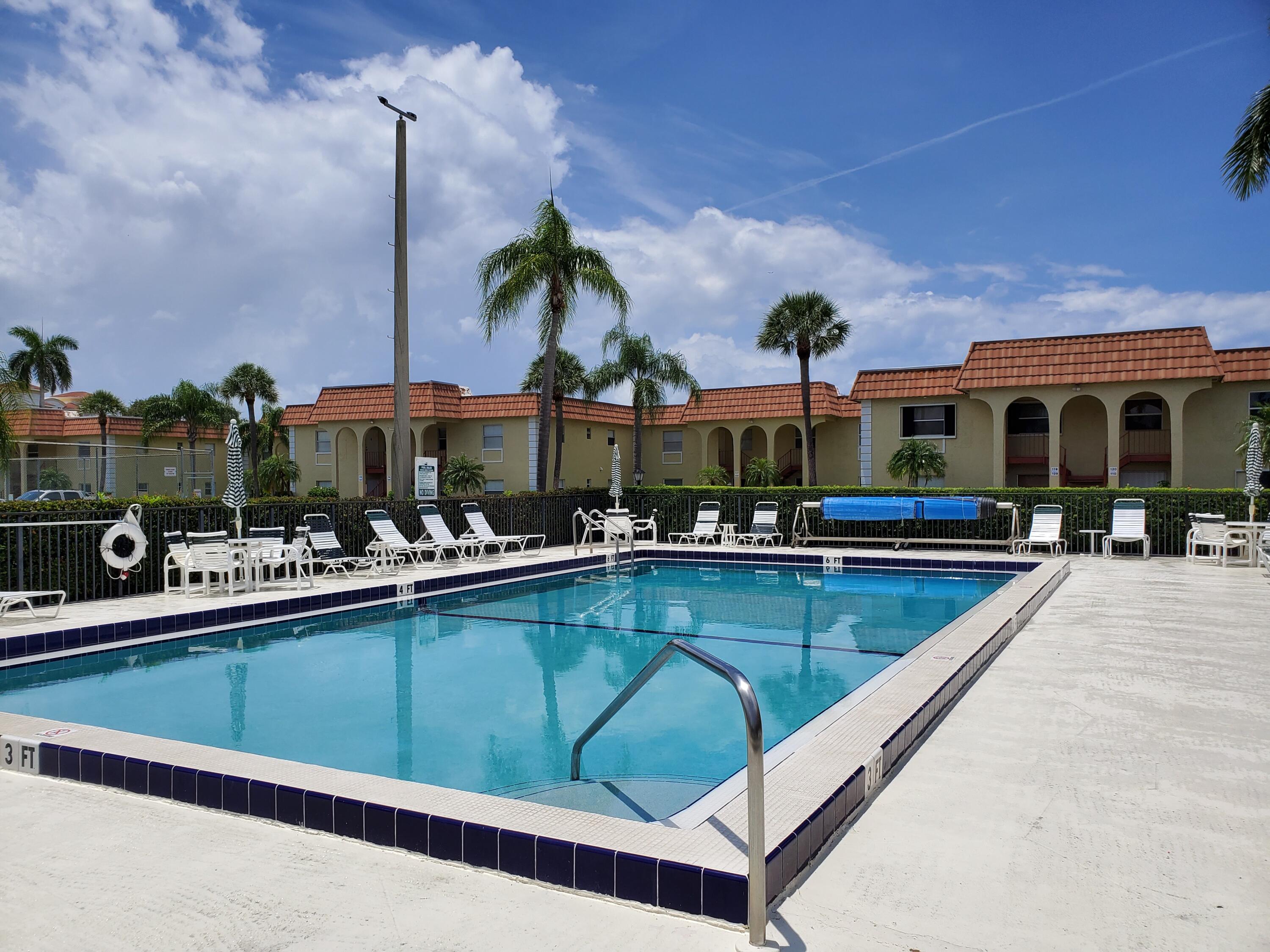 a view of a patio with swimming pool table and chairs