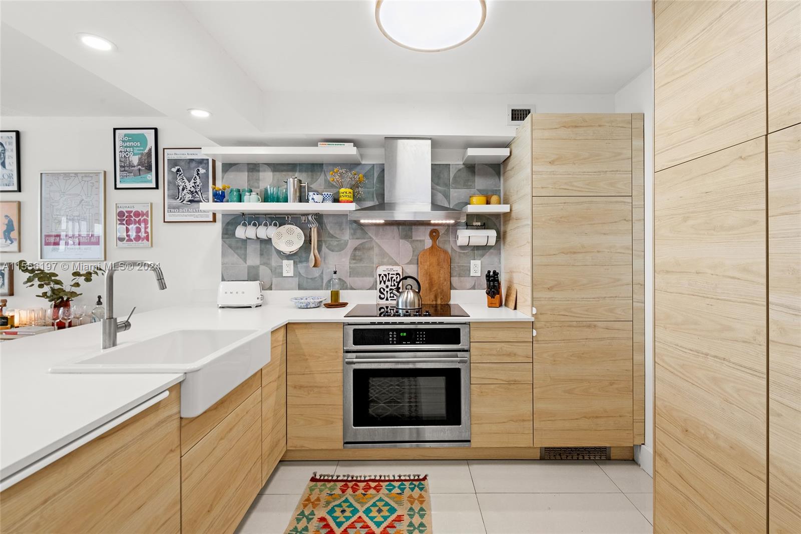 a kitchen with stainless steel appliances granite countertop a stove and a sink