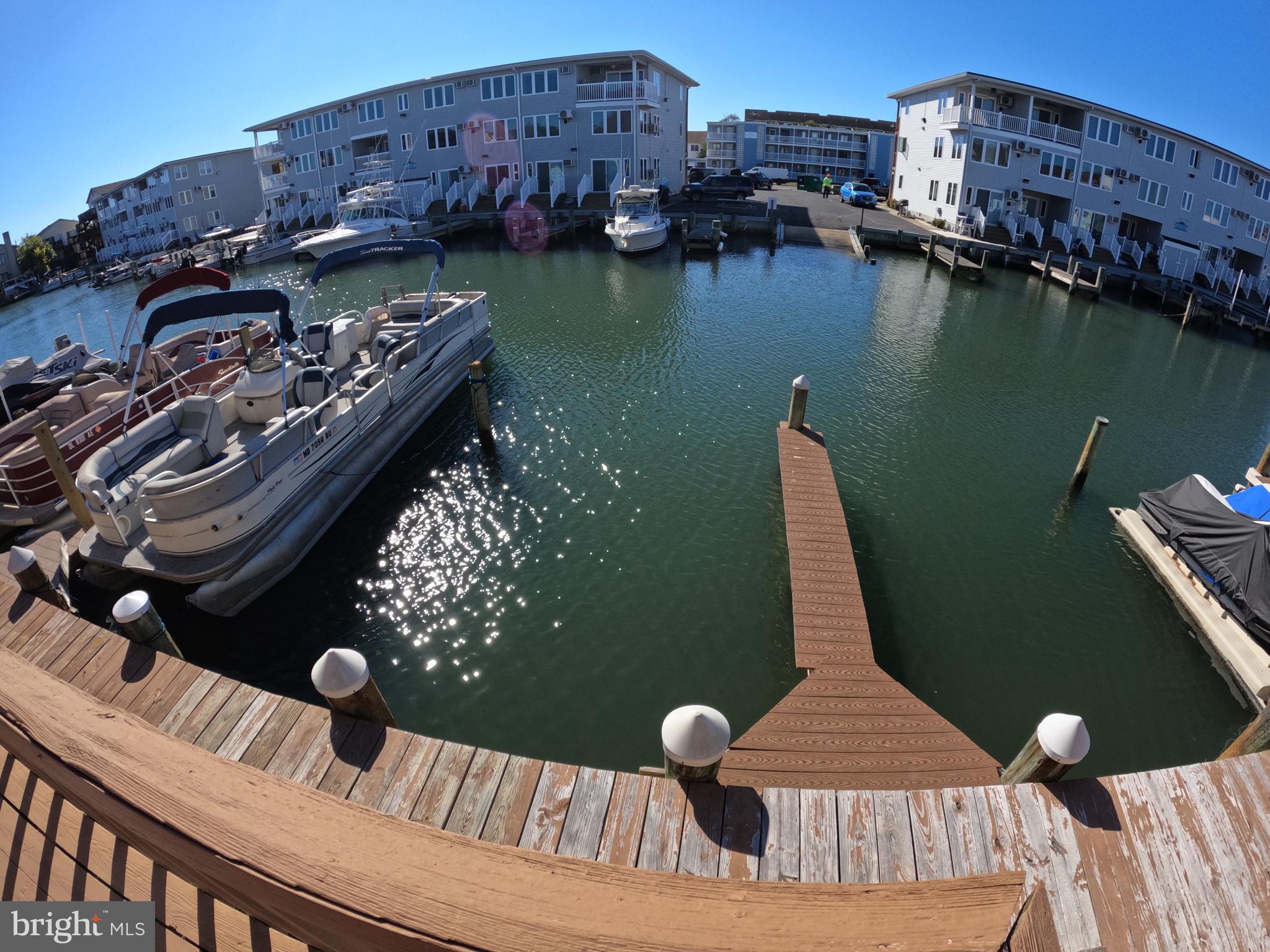 a view of roof deck with chairs and wooden floor