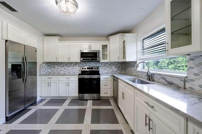 a kitchen with a refrigerator sink and stove