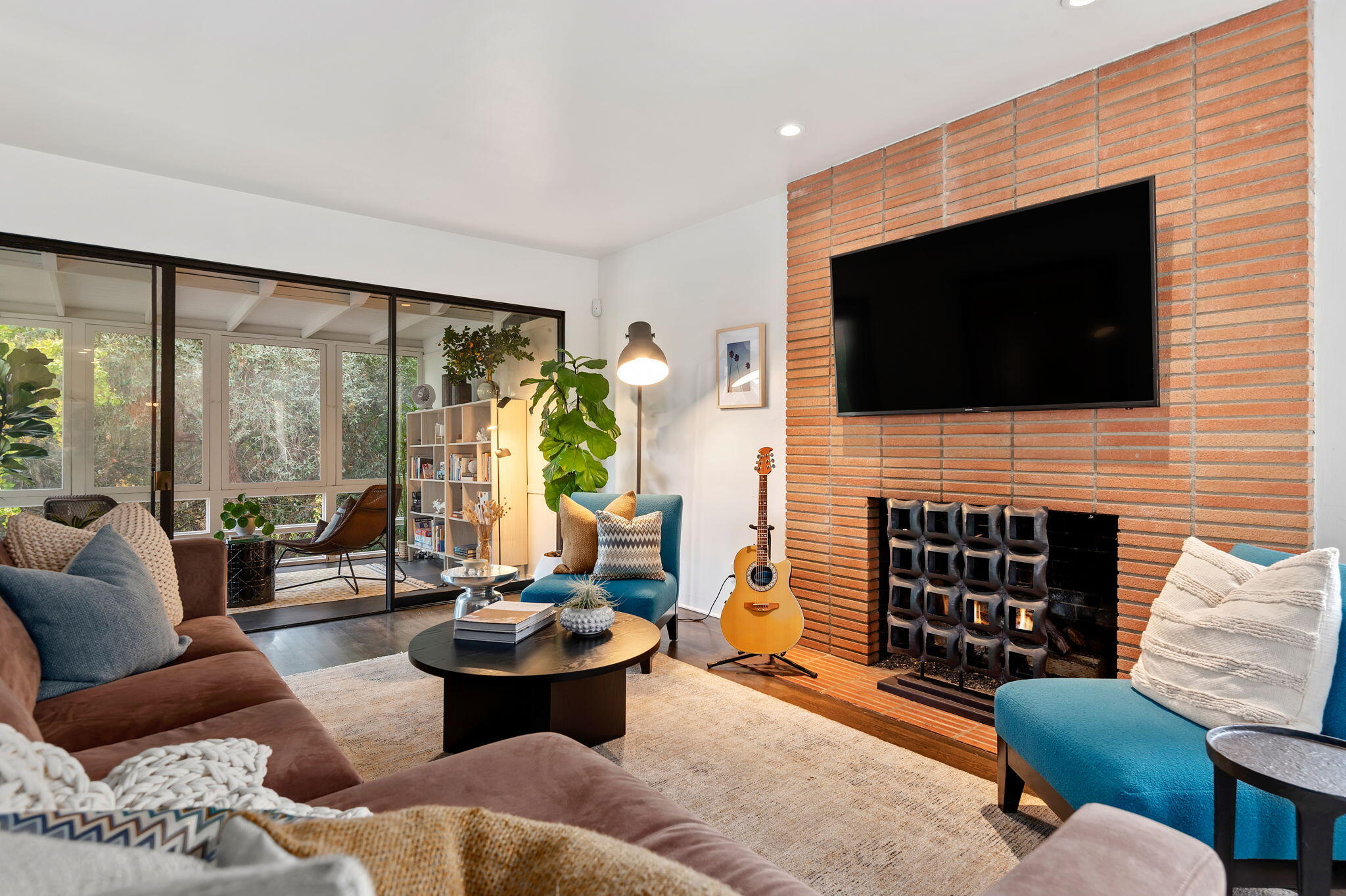 a living room with fireplace furniture and a flat screen tv