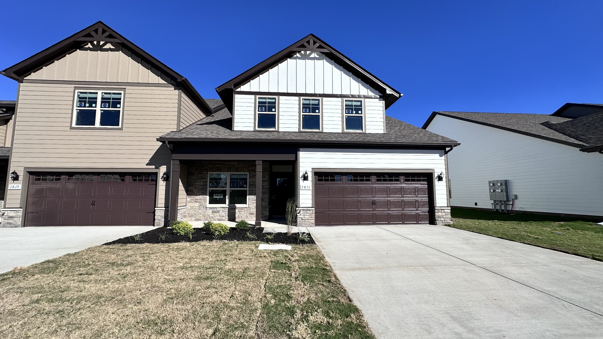 a front view of a house with a yard and garage