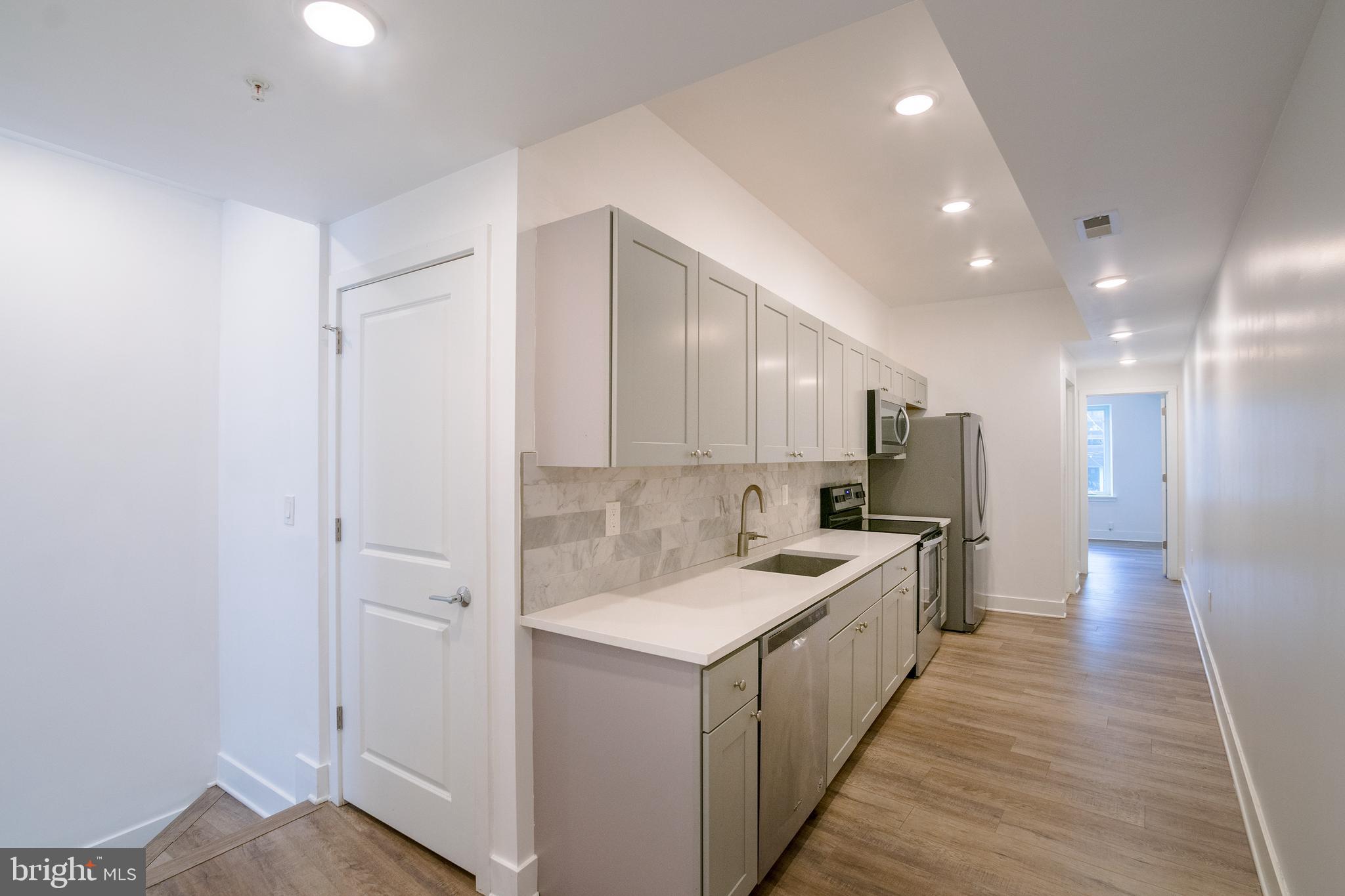 a kitchen with a sink and a refrigerator