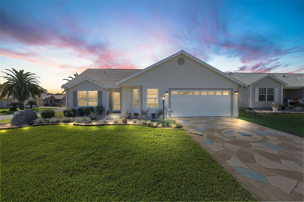 a front view of a house with swimming pool having outdoor seating