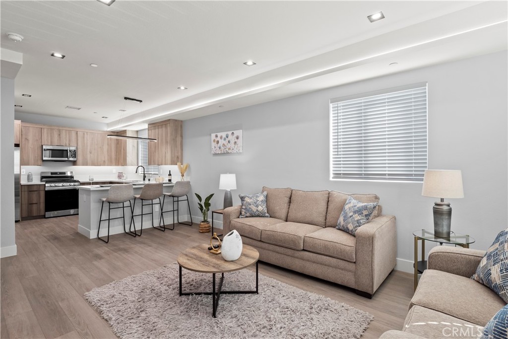 a living room with furniture and kitchen view