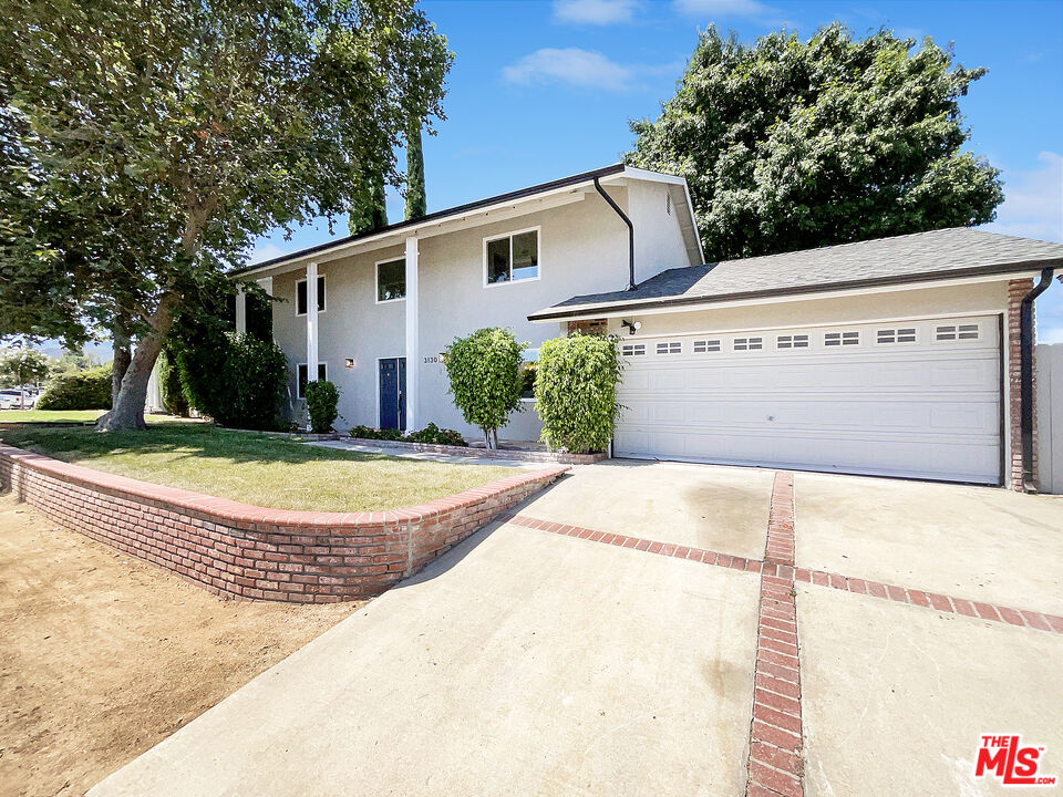 a view of a white house with a large outdoor space