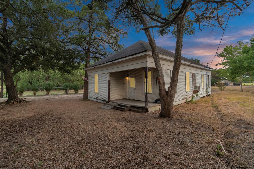 a view of a house with a tree and a yard