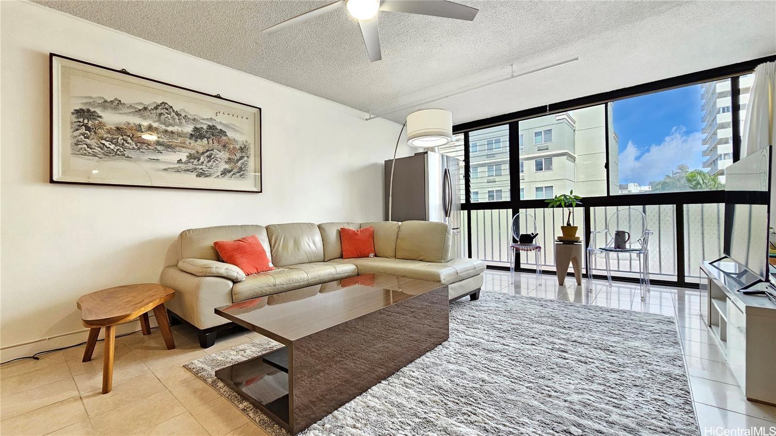 a living room with furniture a rug and a large window