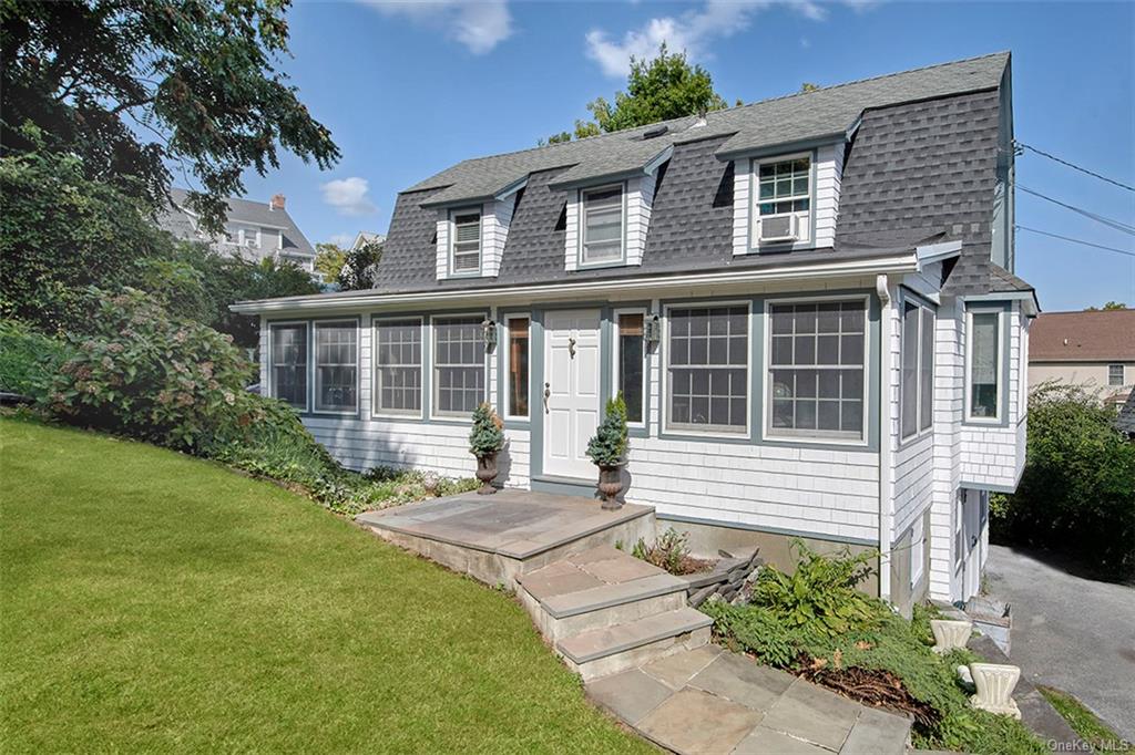 a front view of a house with garden and porch