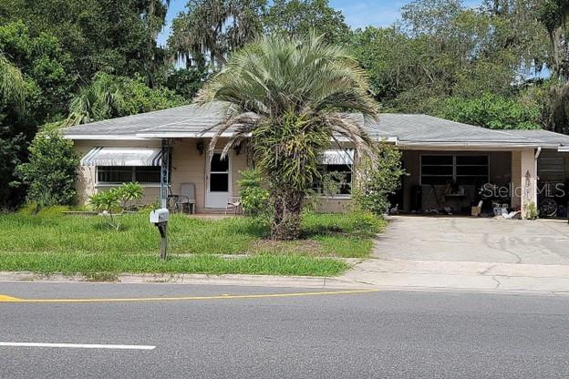 a front view of house with a garden