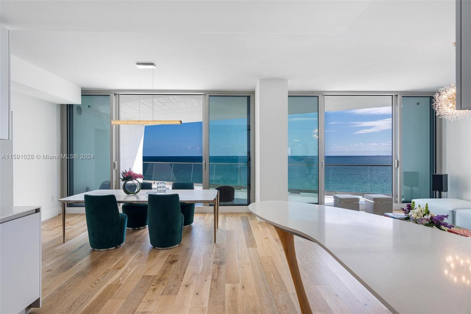 a living room with furniture a large window and wooden floor