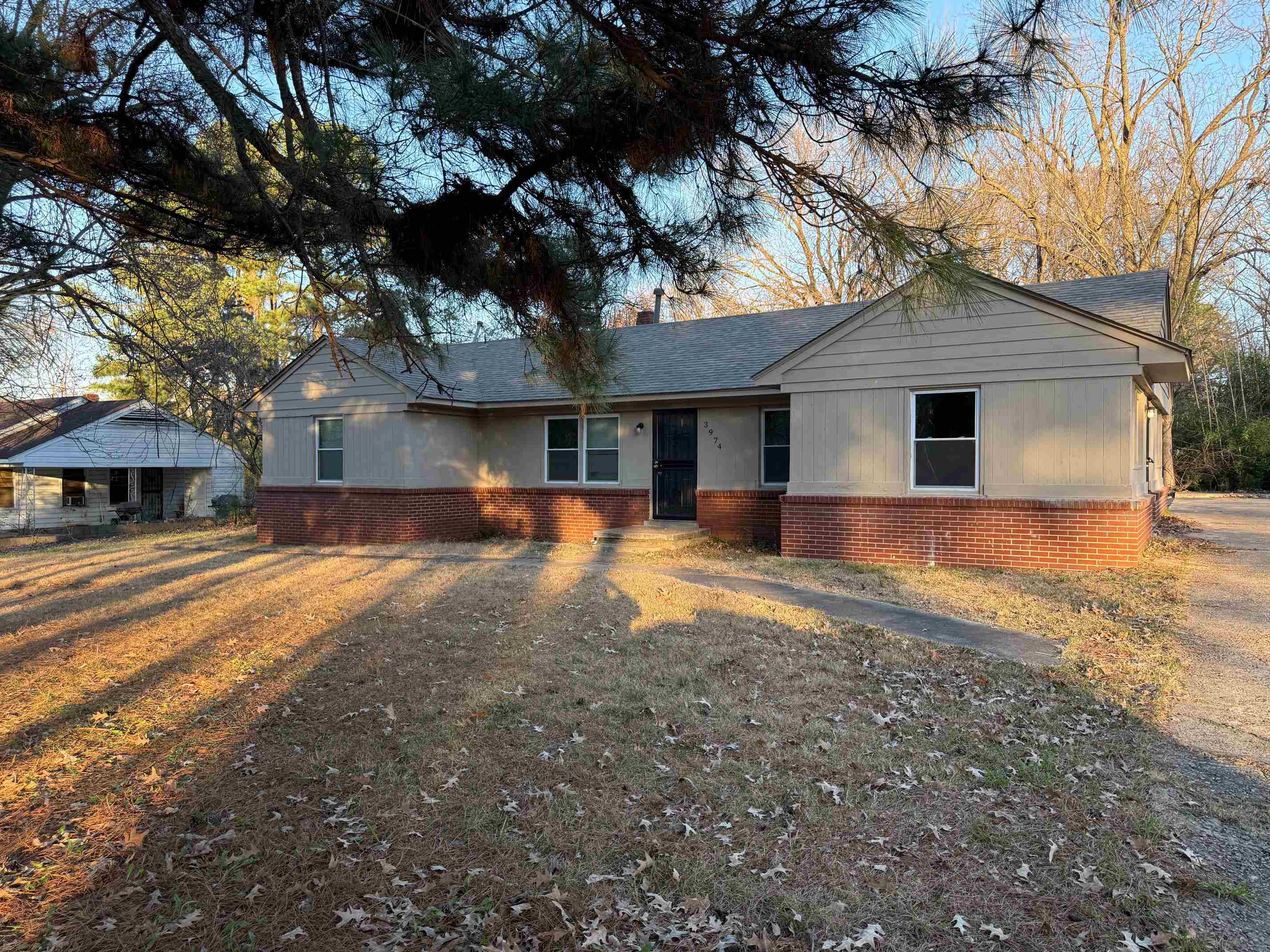 Single story home with a front lawn