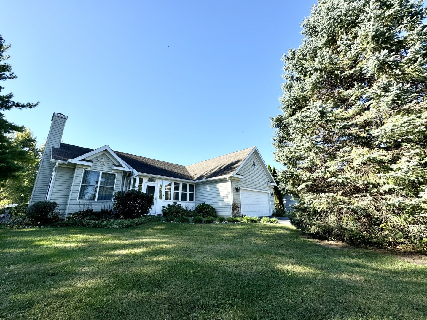 a front view of a house with a garden