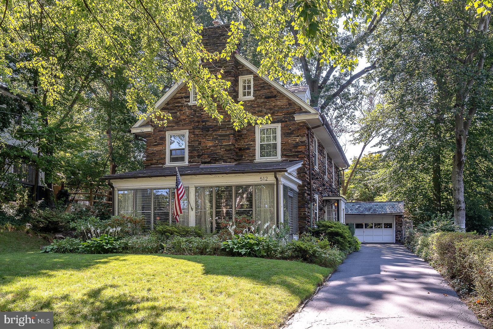 a front view of a house with a yard and potted plants