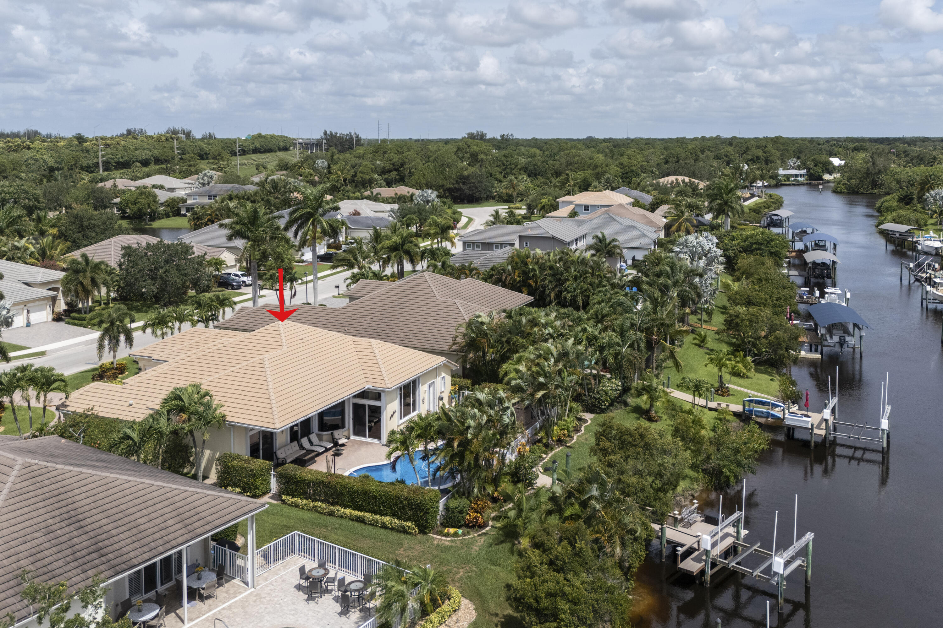 an aerial view of residential houses with outdoor space and lake view