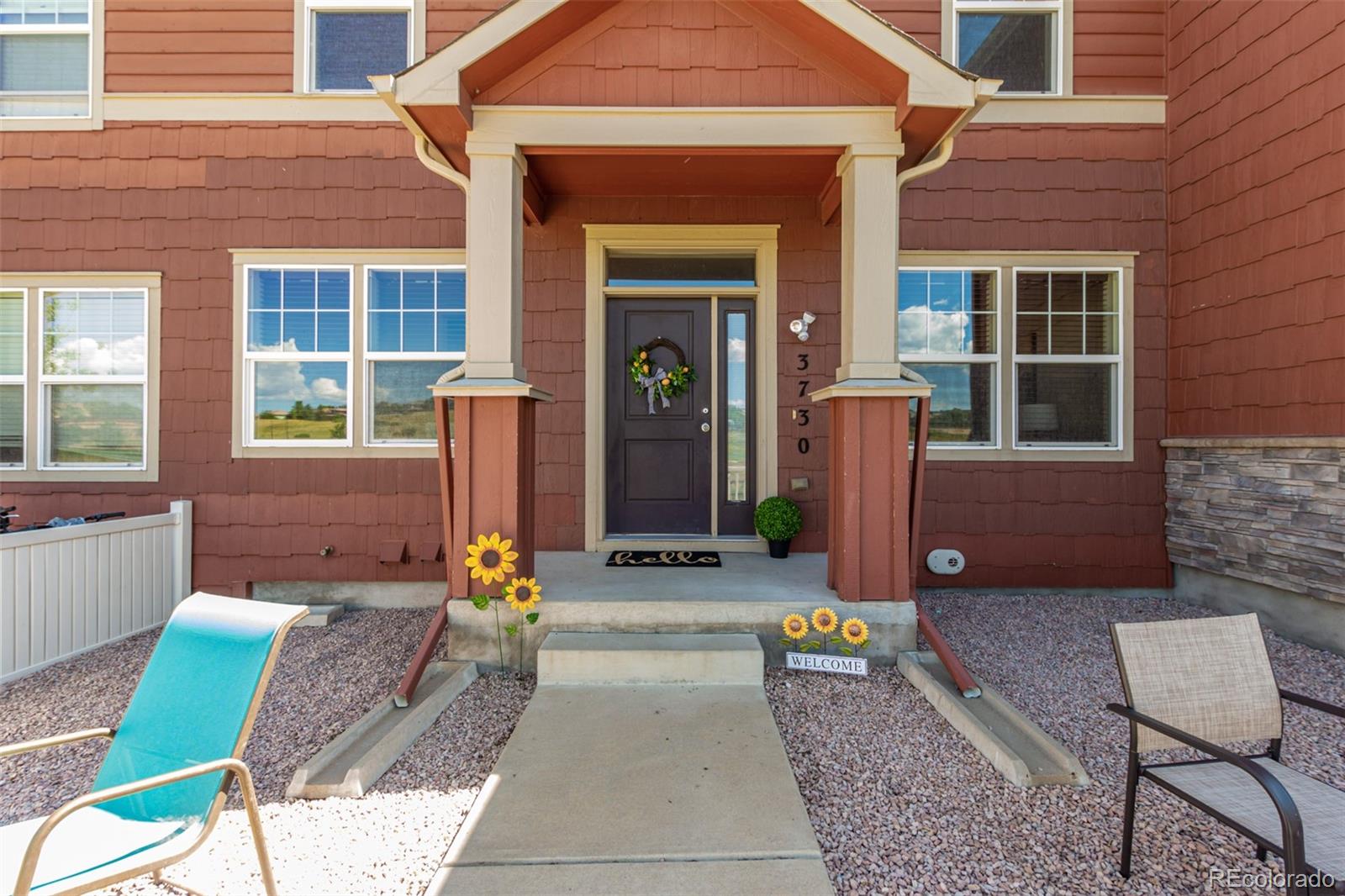 a front view of a house with outdoor seating