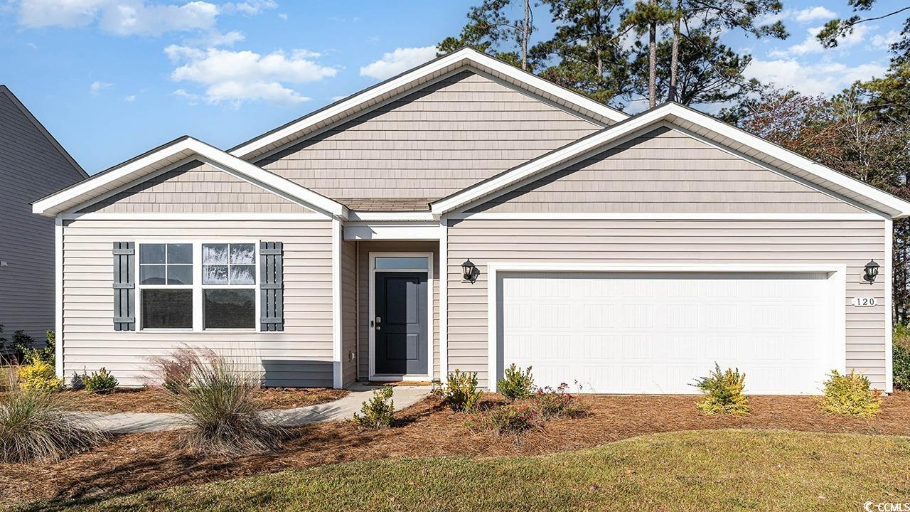 View of front facade featuring a garage