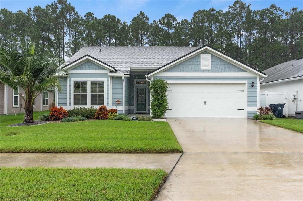 a view of a yard in front view of a house