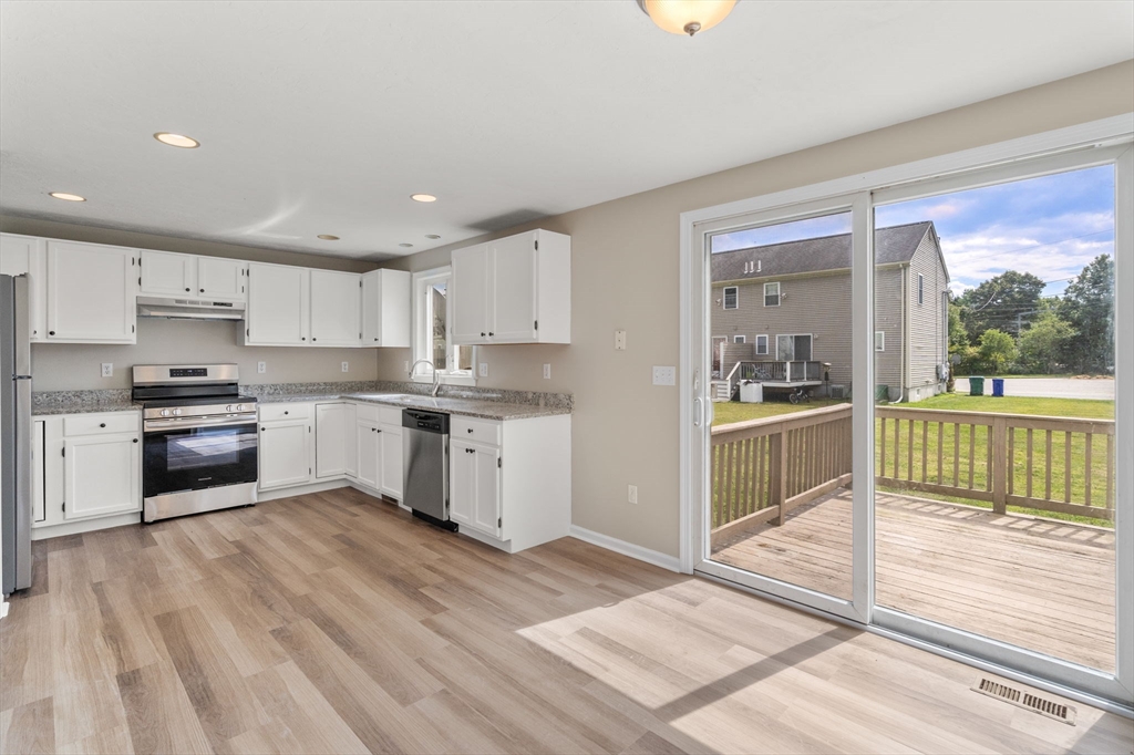 a kitchen with white cabinets and appliances