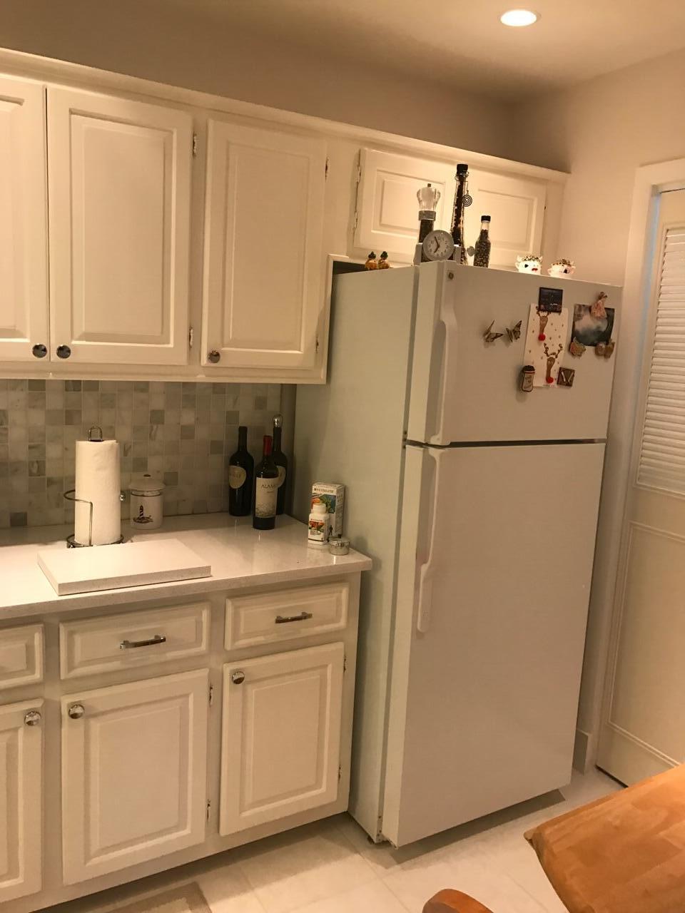 a white refrigerator freezer sitting inside of a kitchen