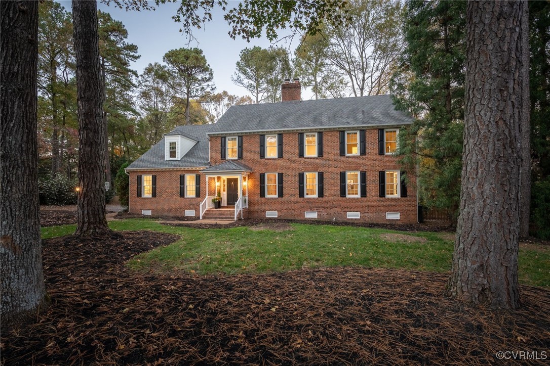 a view of a house with yard and a garden