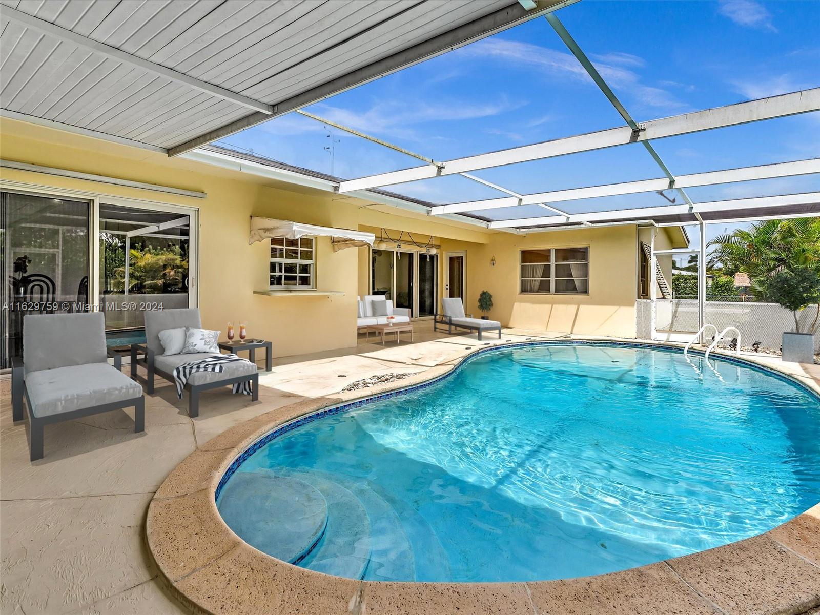 a swimming pool with outdoor seating and yard