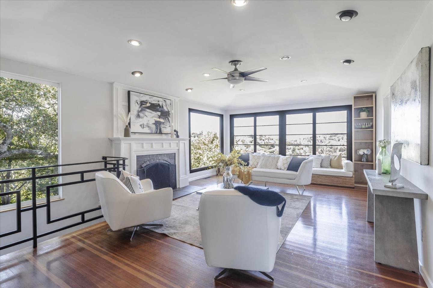 a living room with furniture large window and a fireplace