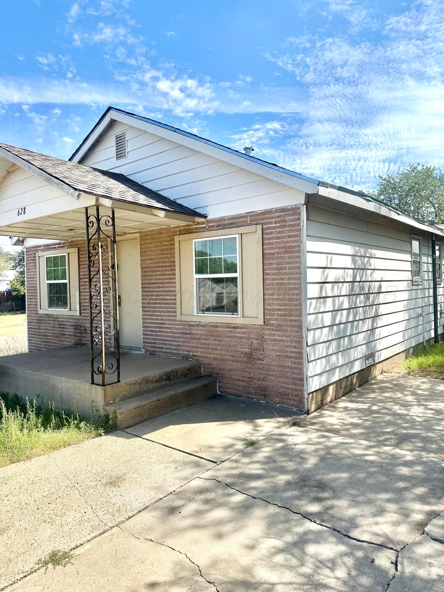 a view of a house with a wooden fence