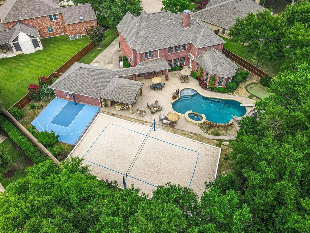 an aerial view of a house with garden space and street view