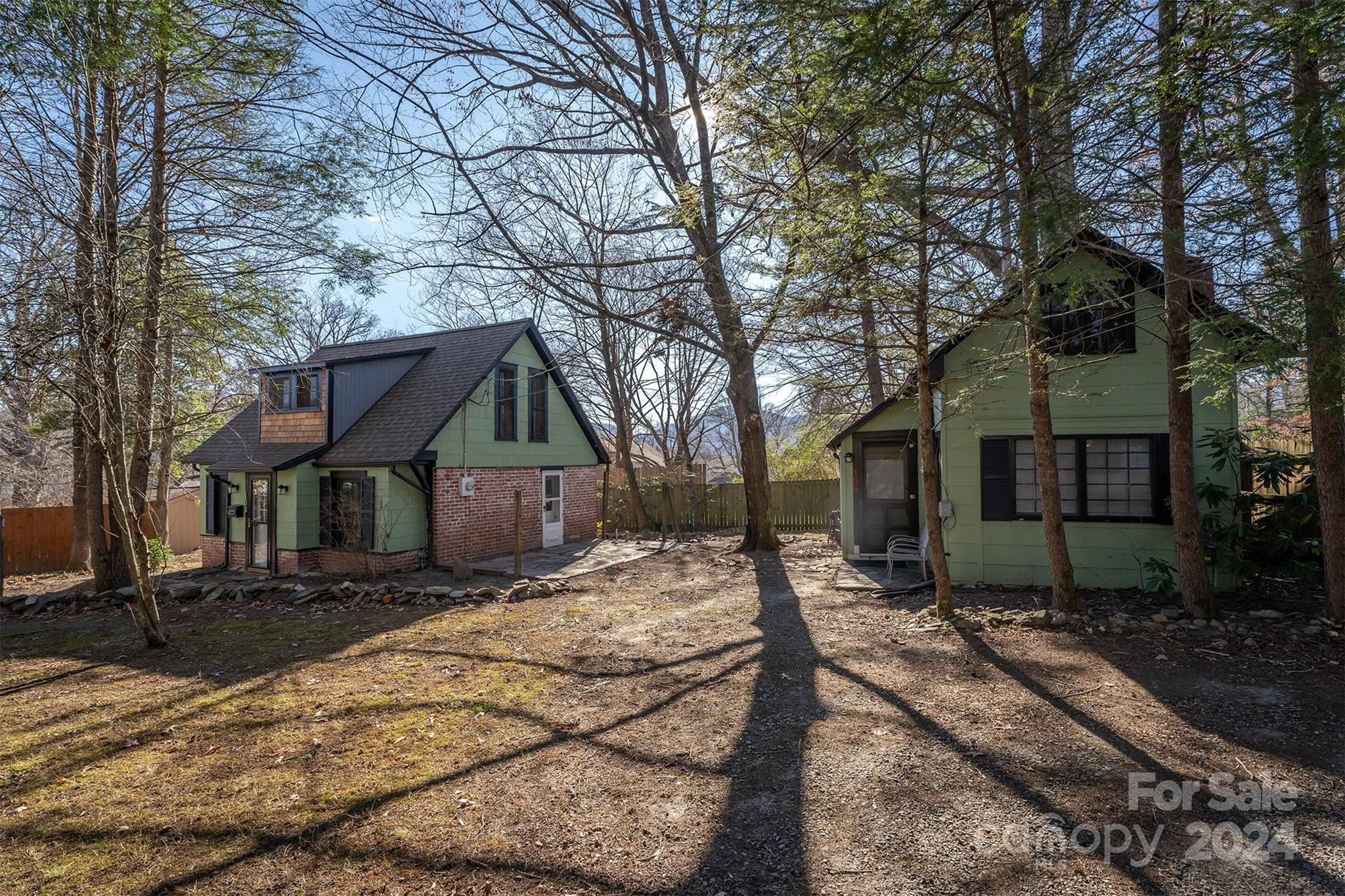 a house that has a tree in front of it